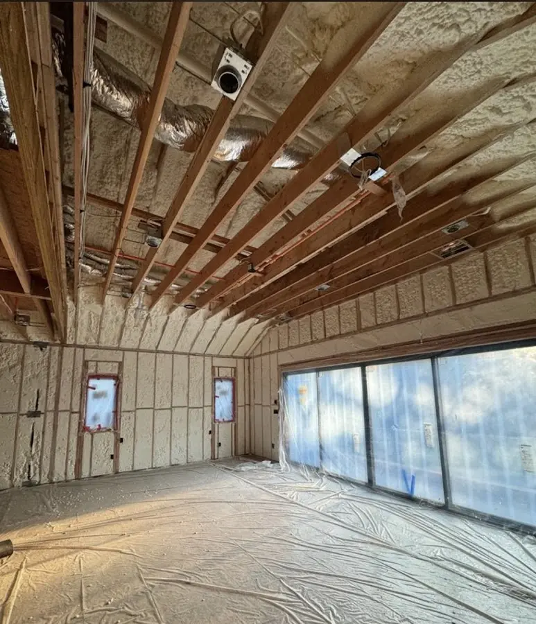 Interior walls and ceiling insulated with spray foam during new construction in Hightstown